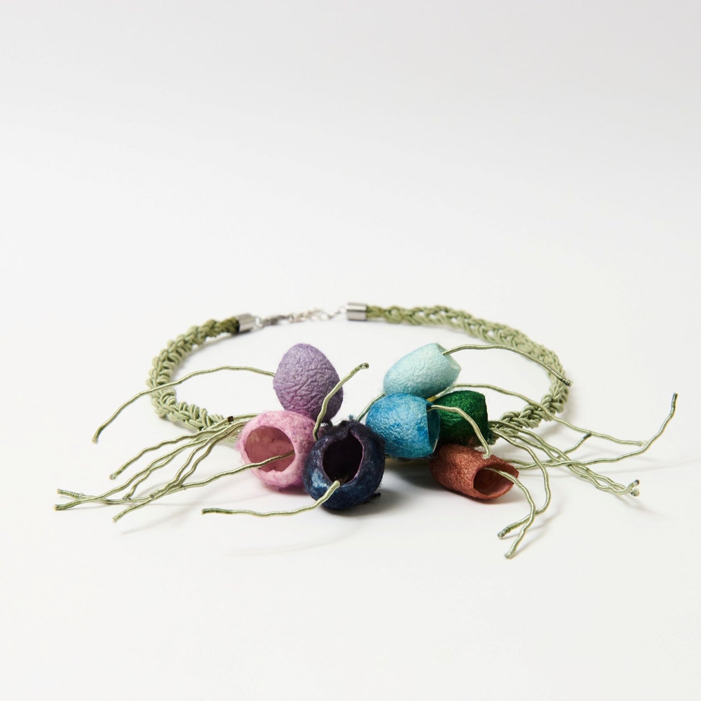 Colorful necklace with silk cocoons on a white background
