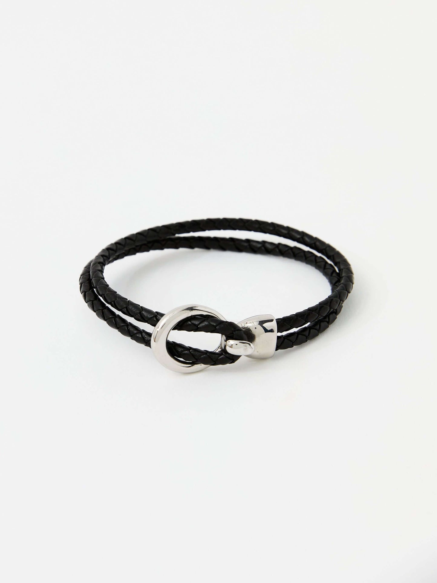 Black braided leather bracelet with a sleek silver loop and knot clasp, showcasing a modern and minimalist style.
