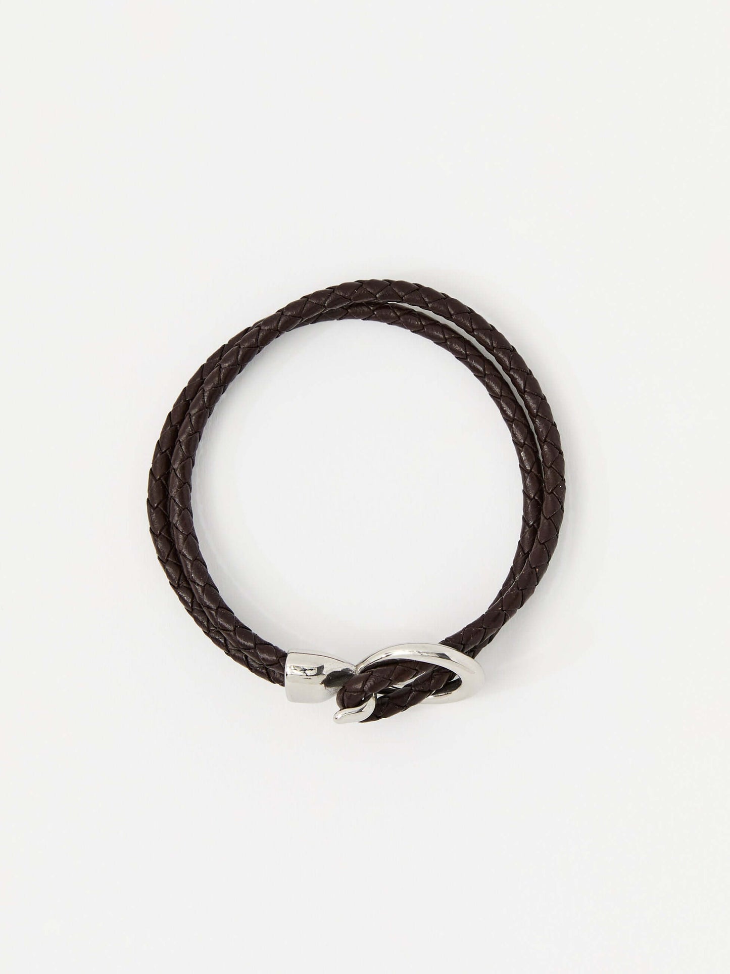 Brown braided leather bracelet with a sleek silver loop and knot clasp, showcasing a modern and minimalist style.