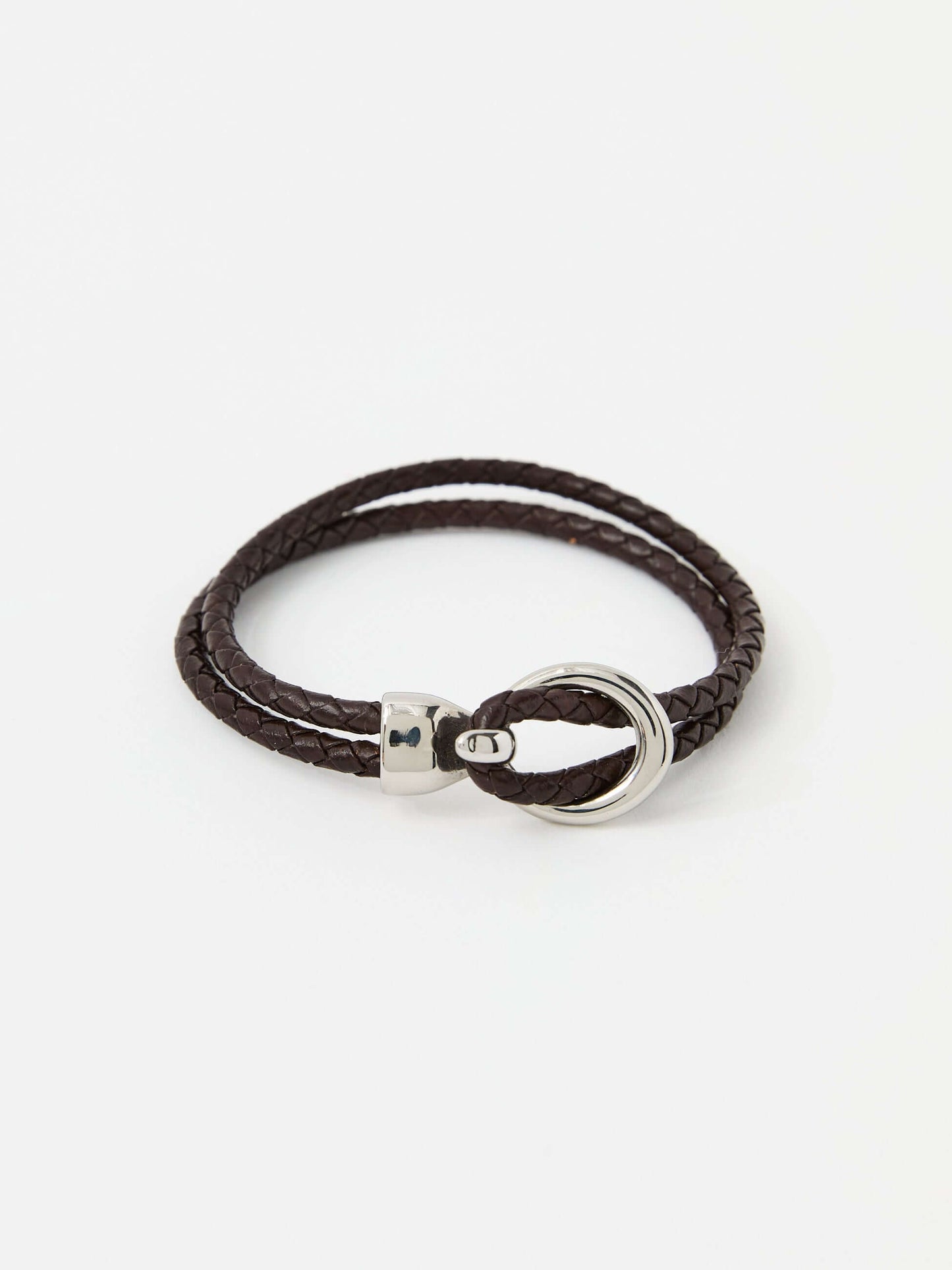 Brown braided leather bracelet with a sleek silver loop and knot clasp, showcasing a modern and minimalist style.