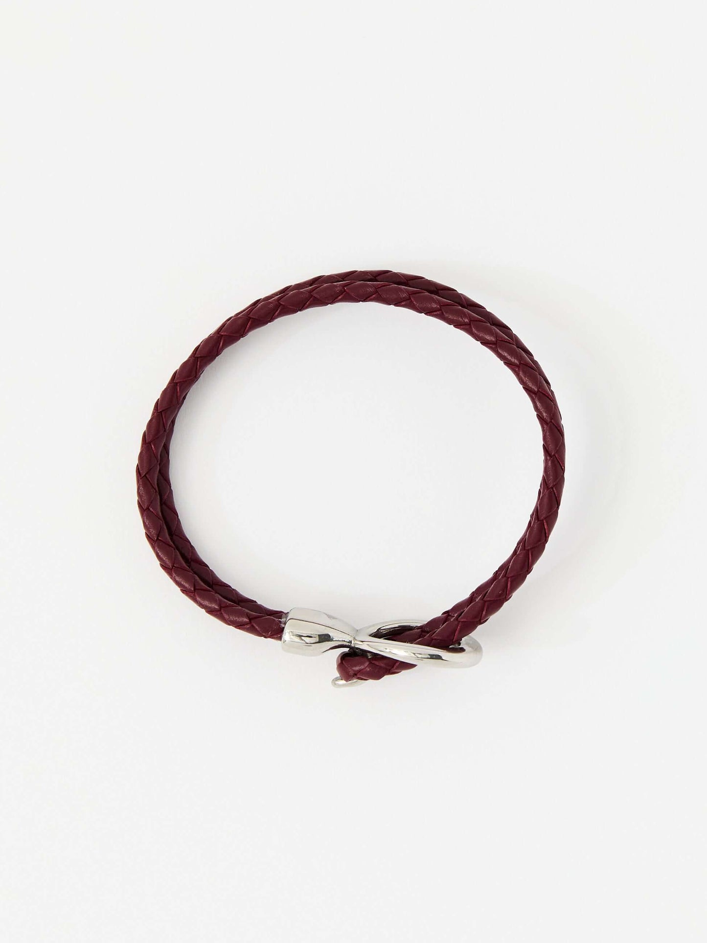 Red braided leather bracelet with a sleek silver loop and knot clasp, showcasing a modern and minimalist style.