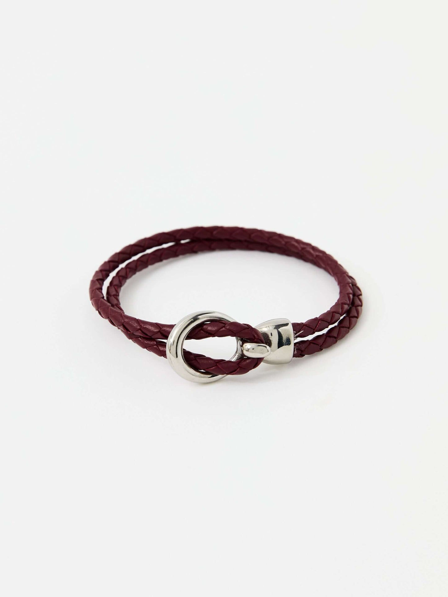 Red braided leather bracelet with a sleek silver loop and knot clasp, showcasing a modern and minimalist style.