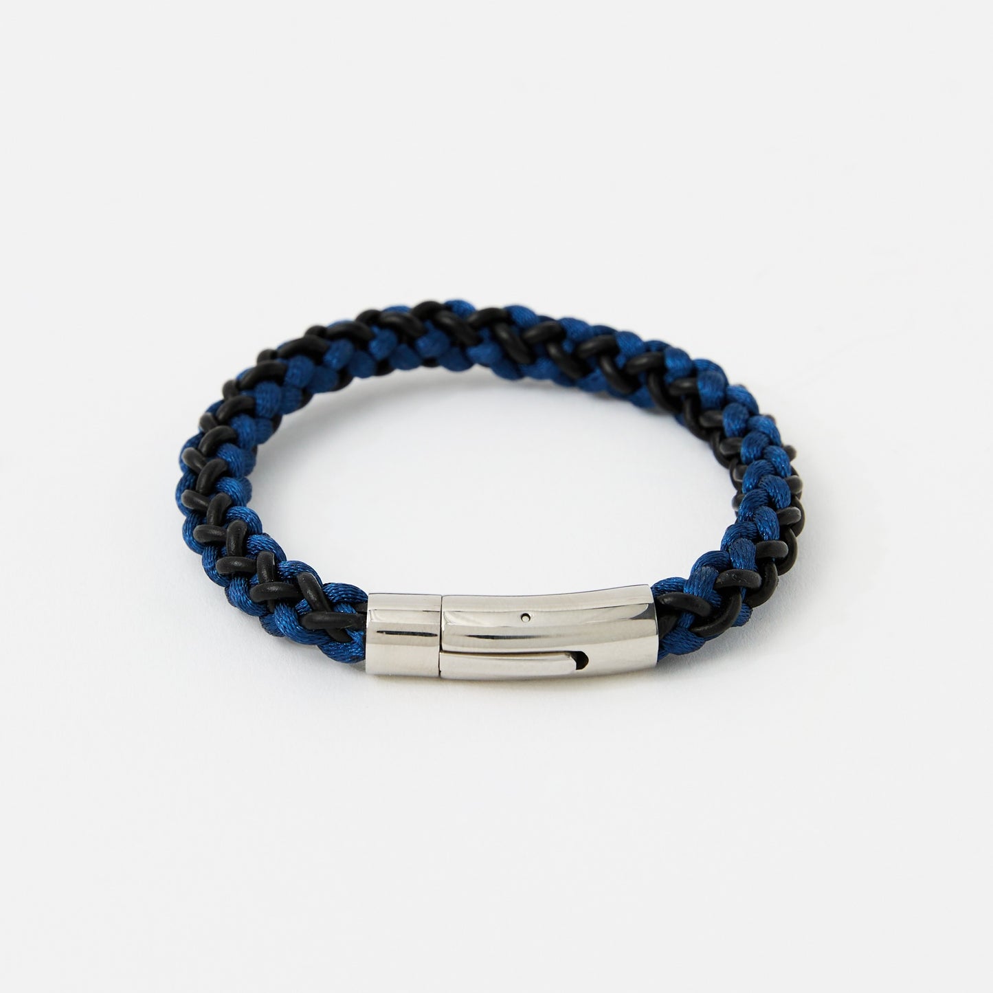 Blue and black braided bracelet with a silver tag on a white background