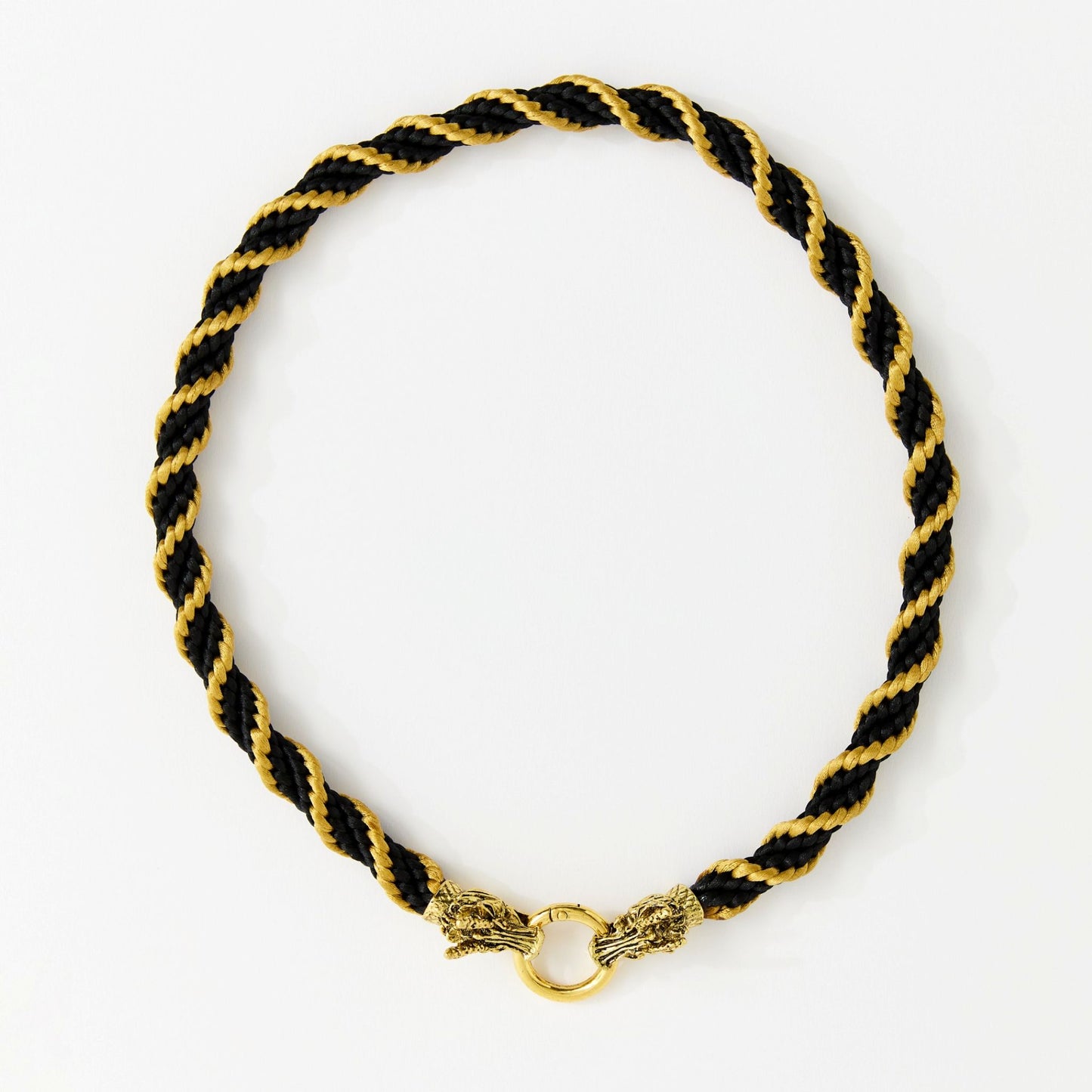 Handmade black and gold spiral satin cord necklace with dragon head clasp, arranged in a full circle on a white background.