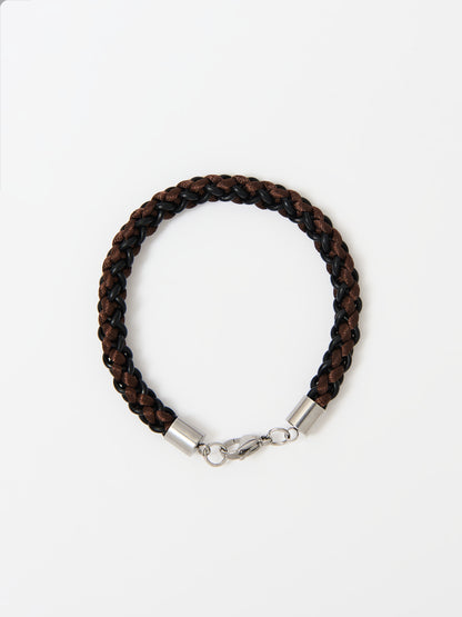 Close-up of a braided bracelet featuring intertwined brown and black materials with stainless steel lobster clasp, displayed on a white background.