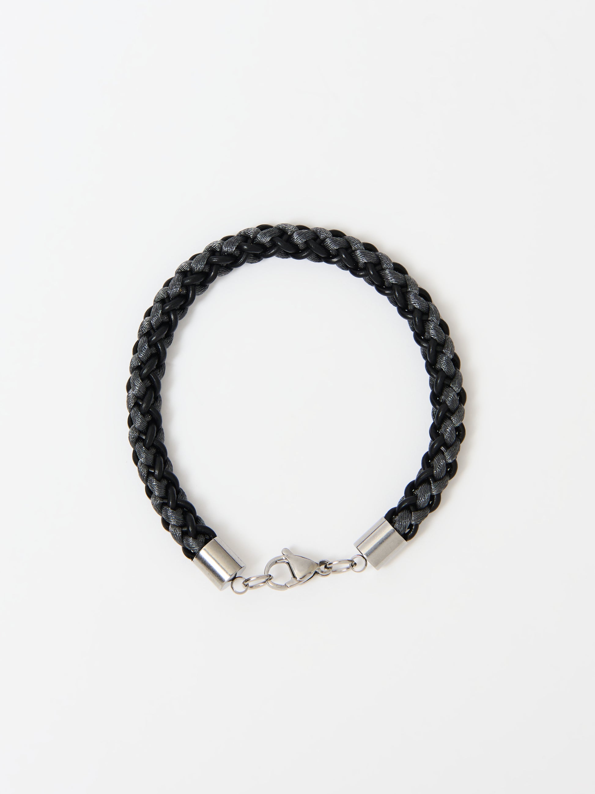 Close-up of a braided bracelet featuring intertwined black and grey materials with stainless steel lobster clasp, displayed on a white background.