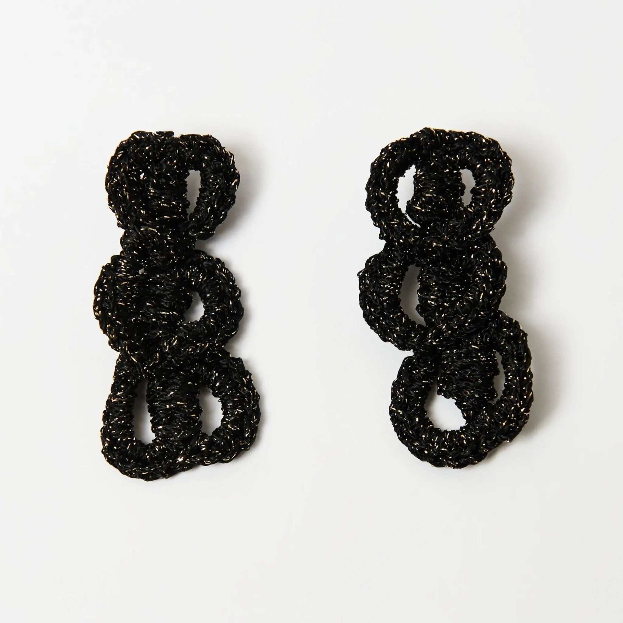 Pair of hand-crocheted black and gold loop earrings displayed flat on a white background.