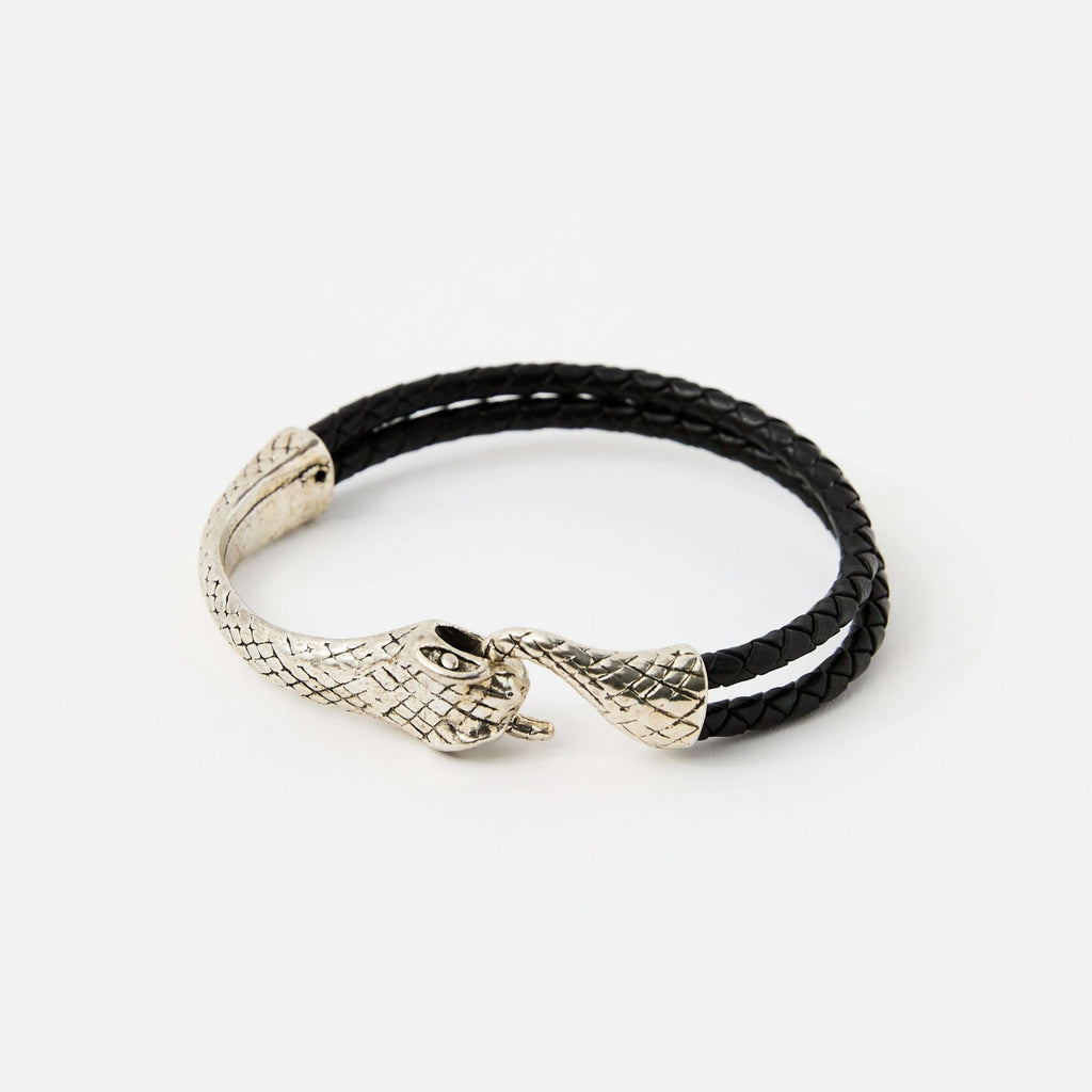 Black braided leather bracelet with a silver snake head clasp, featuring intricate scale details and a sleek, minimalistic design.