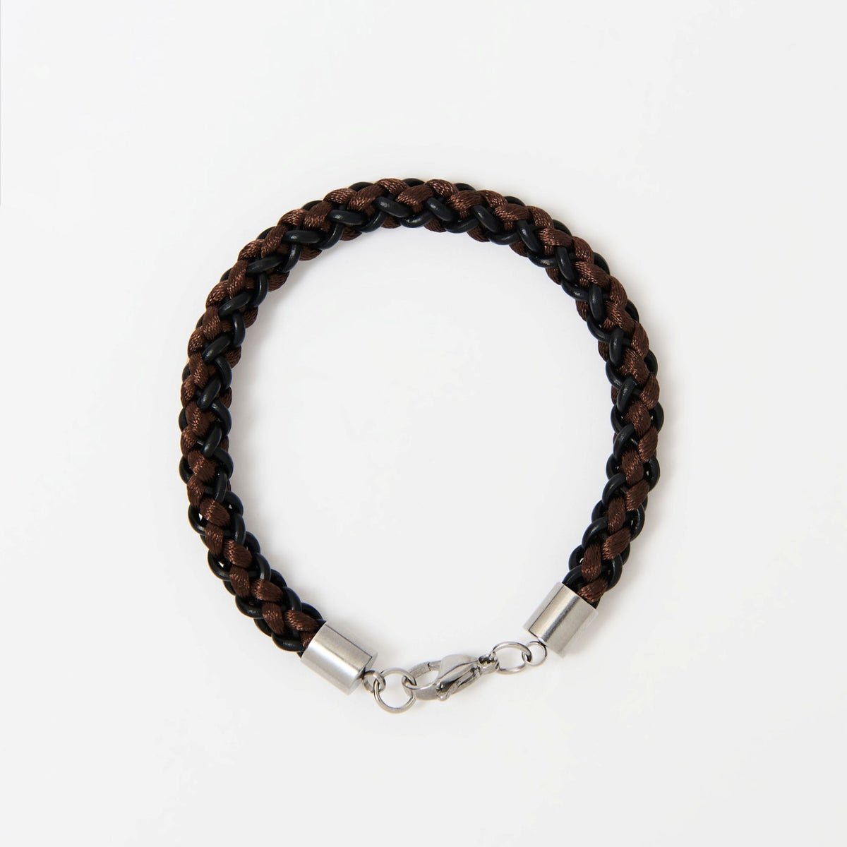 The Marlowe men's braided leather bracelet in Chestnut Brown with a silver lobster clasp, laid flat
