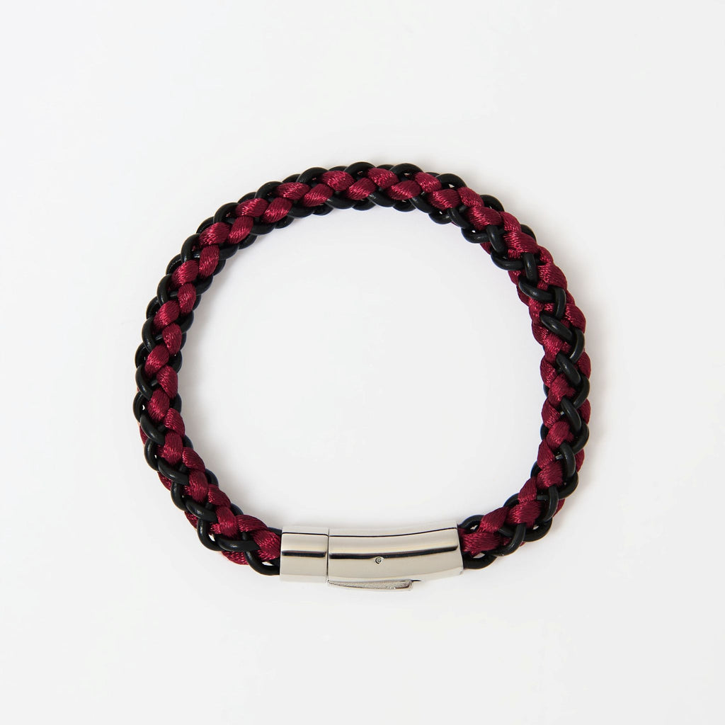 The Arden men's braided leather bracelet in Crimson Red with a polished silver magnetic clasp, laid flat