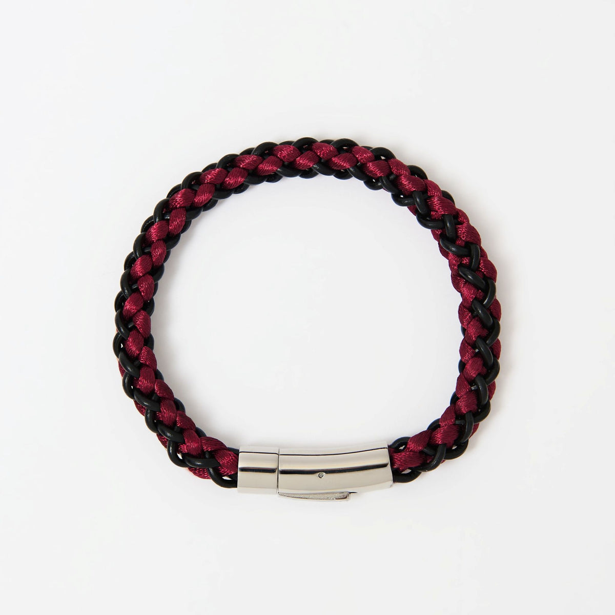 The Arden men's braided leather bracelet in Crimson Red with a polished silver magnetic clasp, laid flat