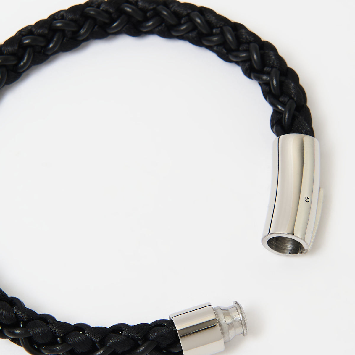 Close-up of the Arden braided leather bracelet in Midnight Black and its polished silver magnetic clasp