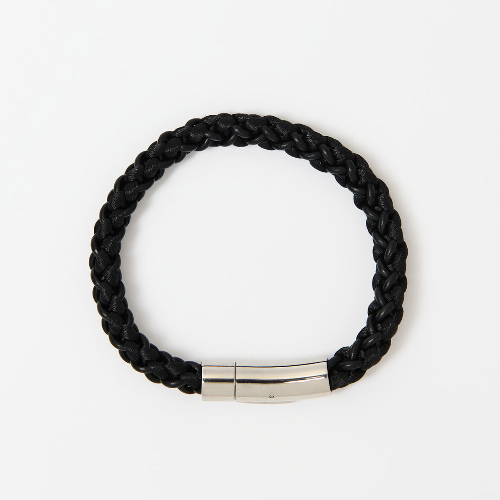 The Arden men's braided leather bracelet in Midnight Black with a polished silver magnetic clasp, laid flat