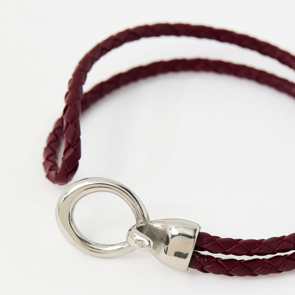 Close-up of the Merle bracelet in Crimson Red showing the braided leather and silver clasp