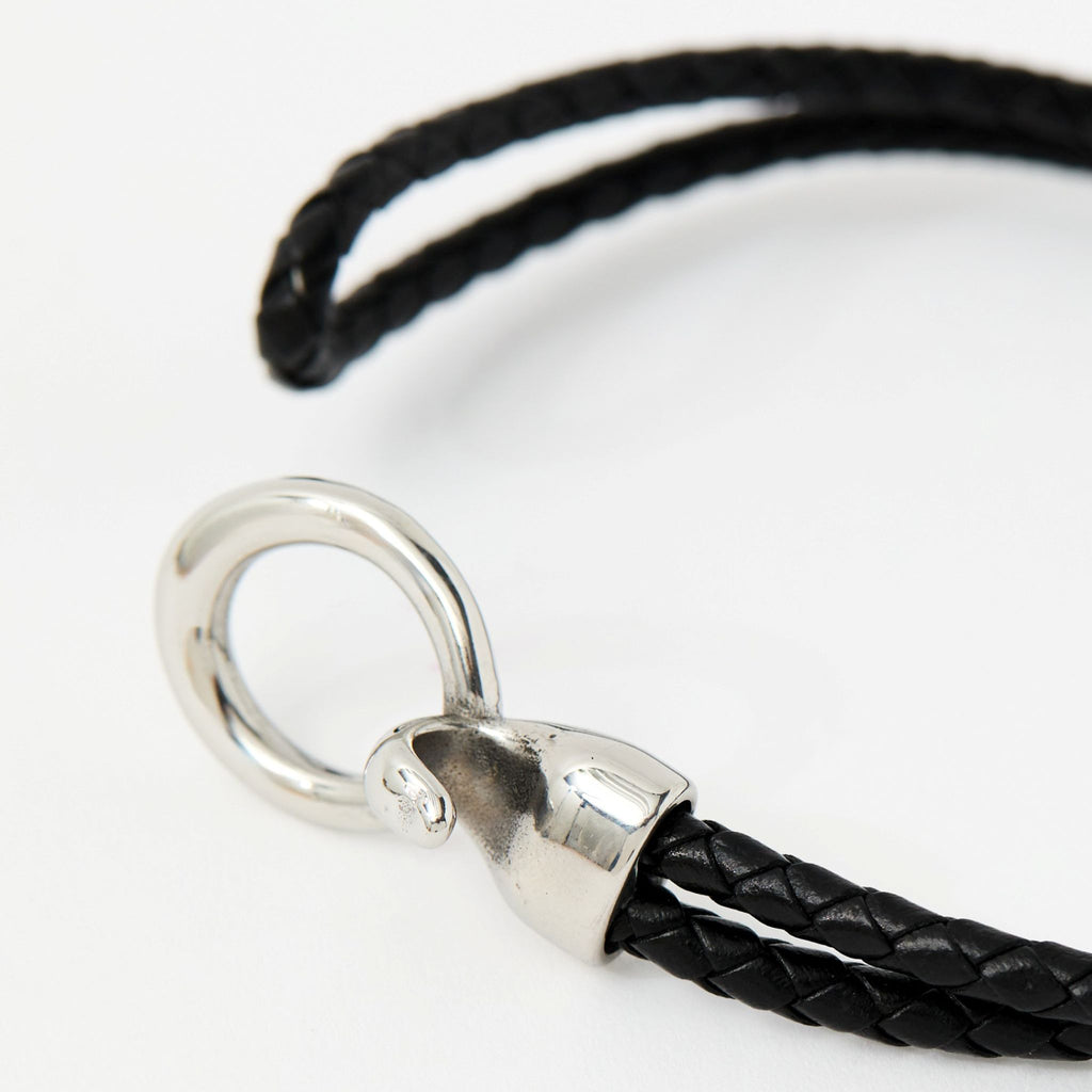Close-up of the Merle bracelet in Midnight Black showing the braided leather and silver clasp