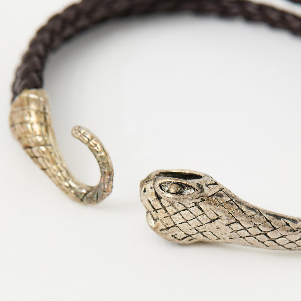 Close-up of the Serin Chestnut Brown braided leather bracelet and its textured silver snake clasp