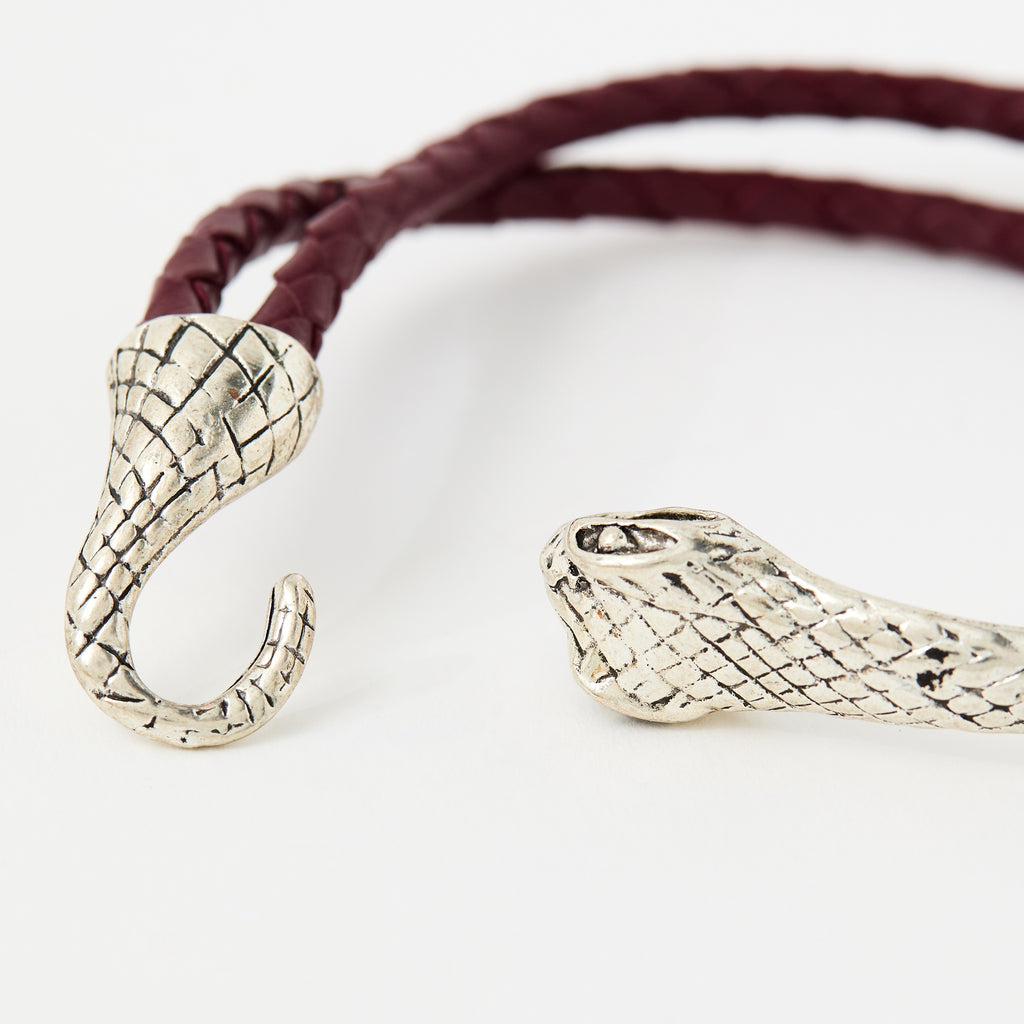Close-up of the Serin Crimson Red braided leather bracelet and its textured silver snake clasp