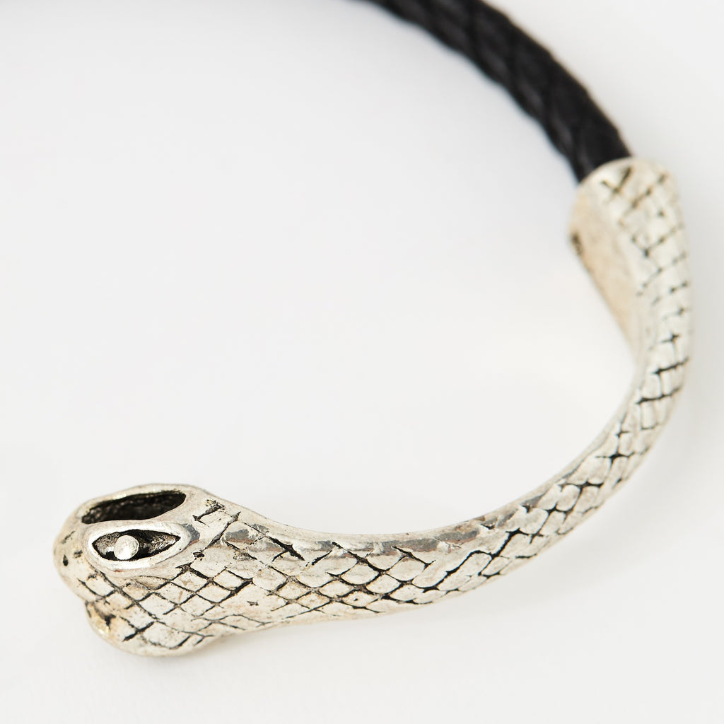 Close-up of the Serin Midnight Black braided leather bracelet and its textured silver snake clasp