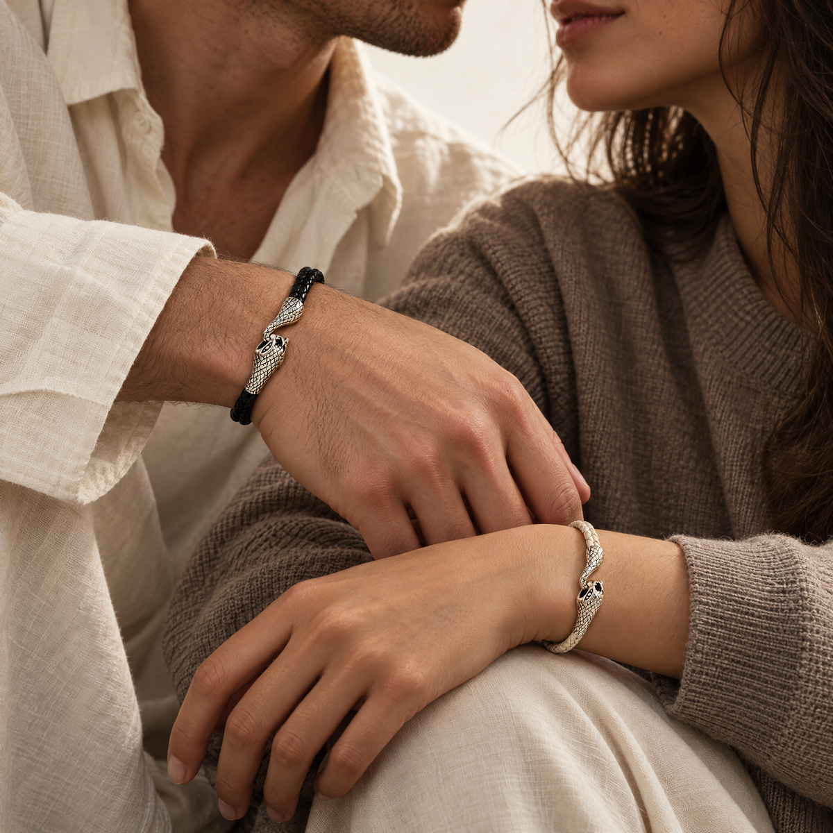 The Serin leather bracelet in Midnight Black with a sculptural silver snake clasp, worn by a couple with wrists together - Lodorfo