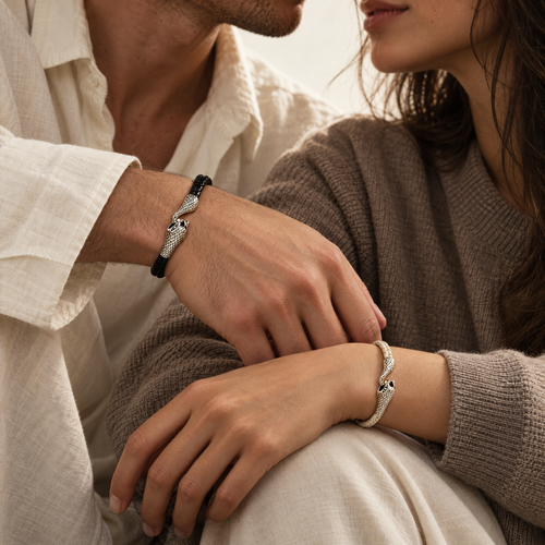 The Serin leather bracelet in Midnight Black with a sculptural silver snake clasp, worn by a couple with wrists together - Lodorfo