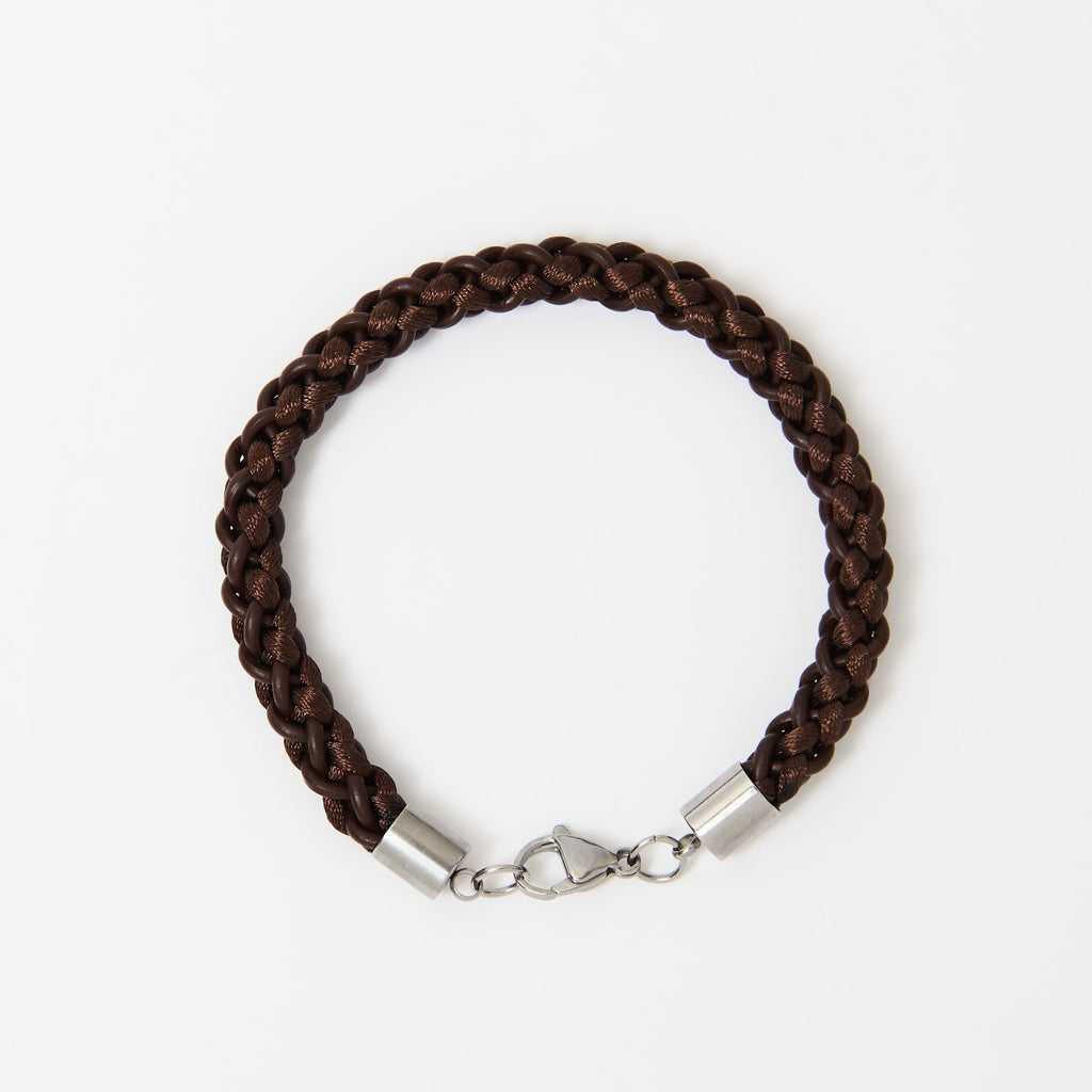 Brown braided bracelet with stainless steel clasp on a white background