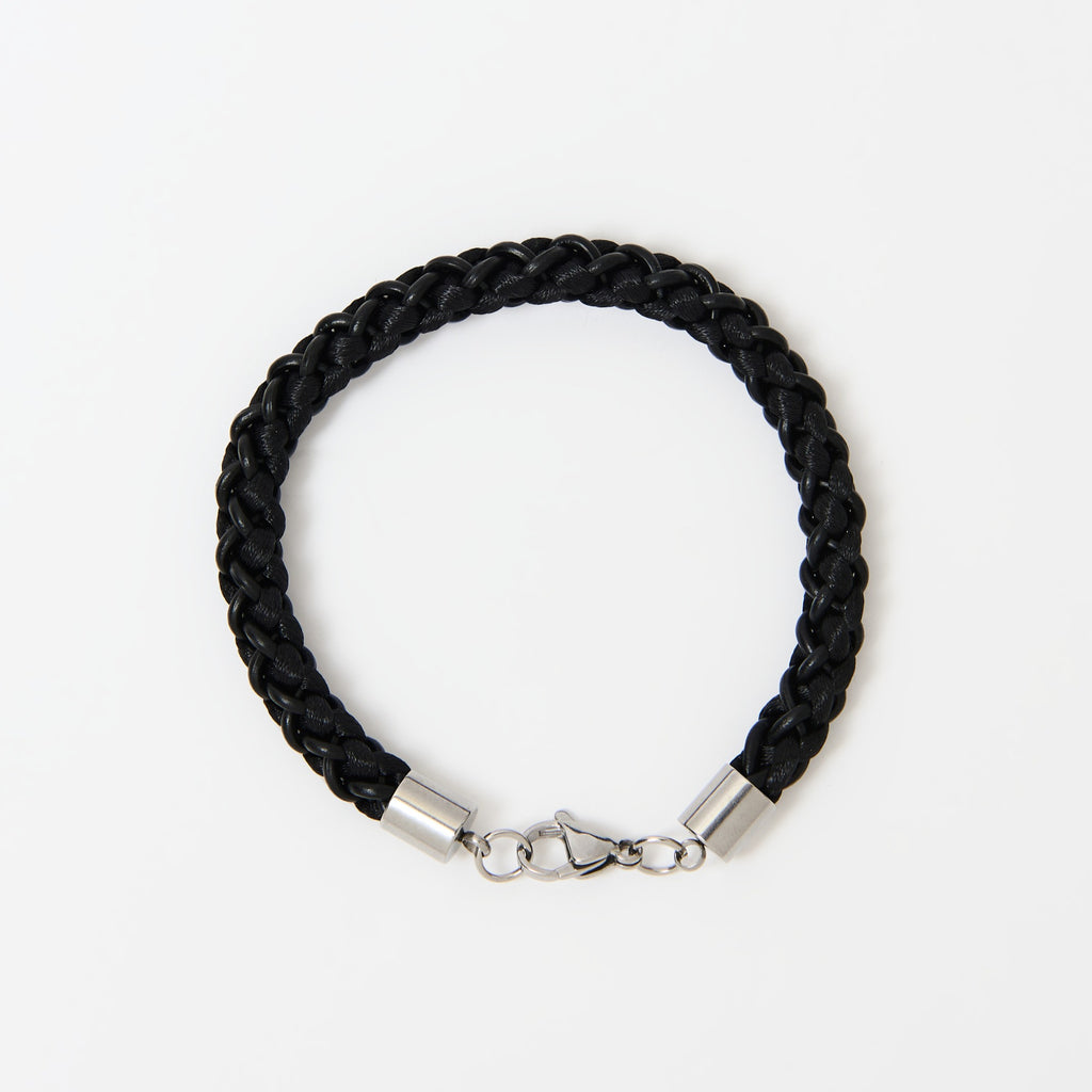 Black braided bracelet with stainless steel clasp on a white background