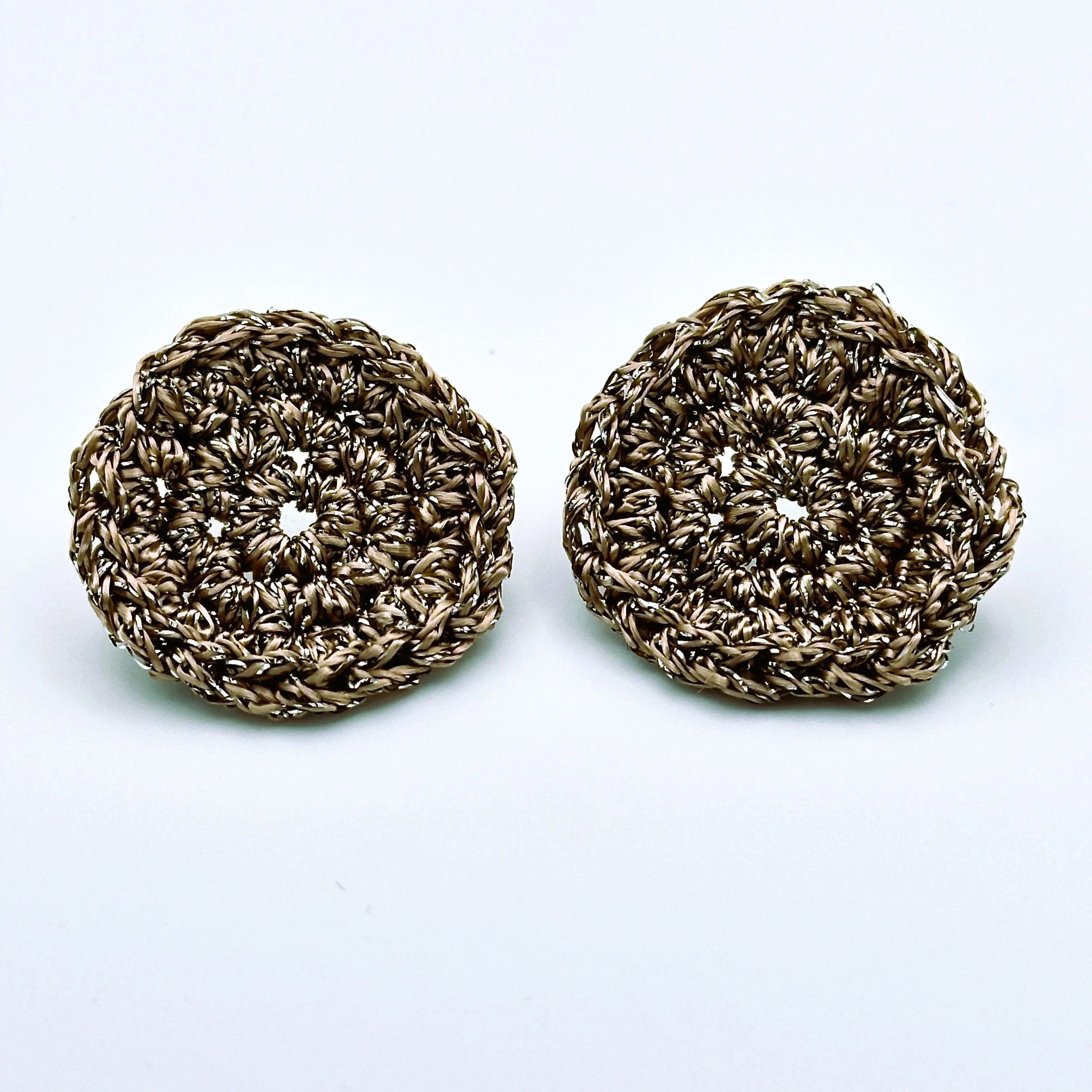 Pair of handmade copper-tone disc earrings with a textured, crochet-style finish and subtle metallic shine.