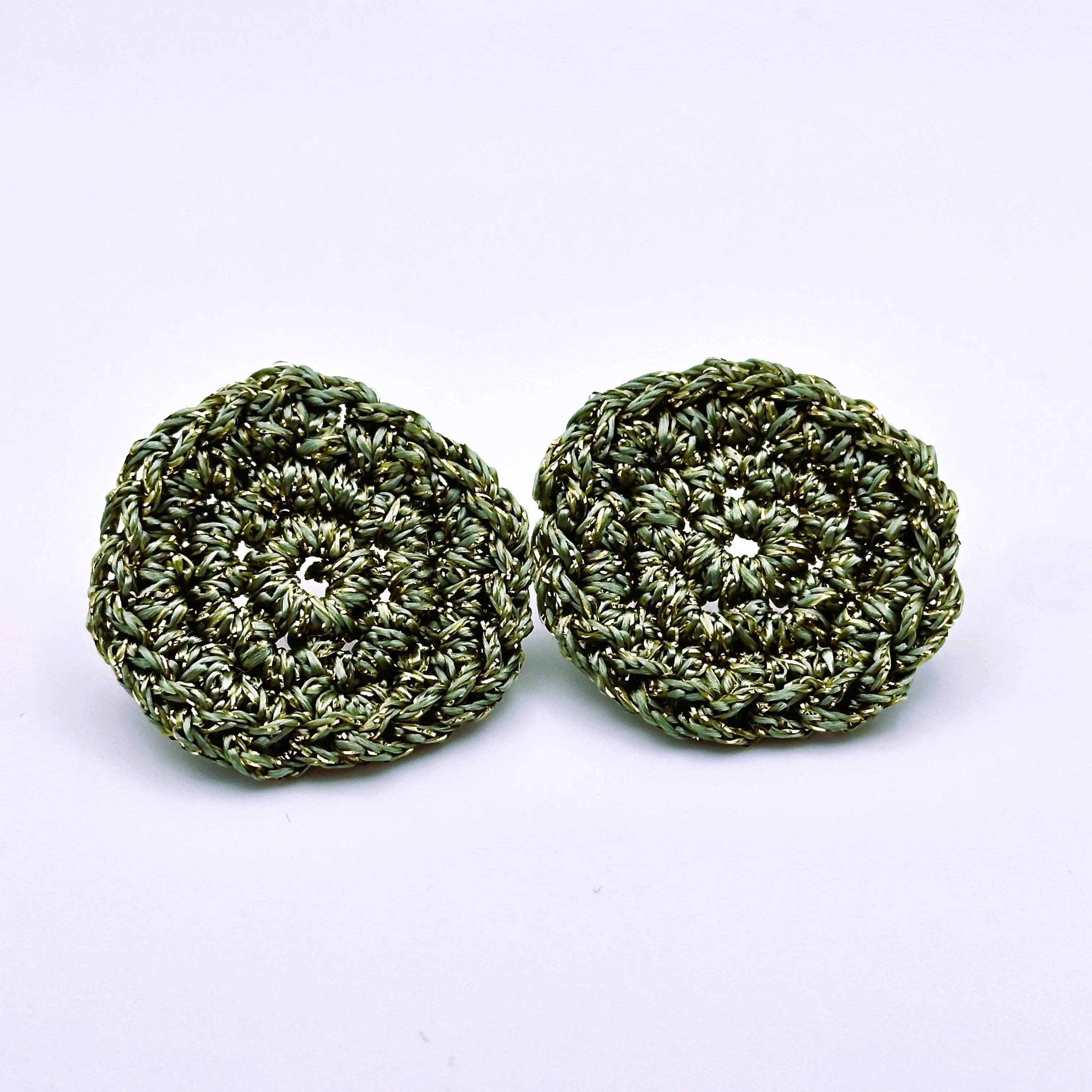 Green crocheted disc earrings with a lustrous finish, crafted in a lightweight circular design ideal for everyday statement wear.