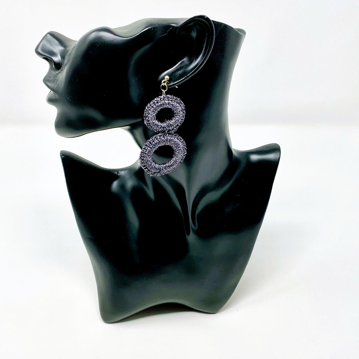 The Sienna charcoal grey crochet double-ring earring shown on a black display bust - Lodorfo