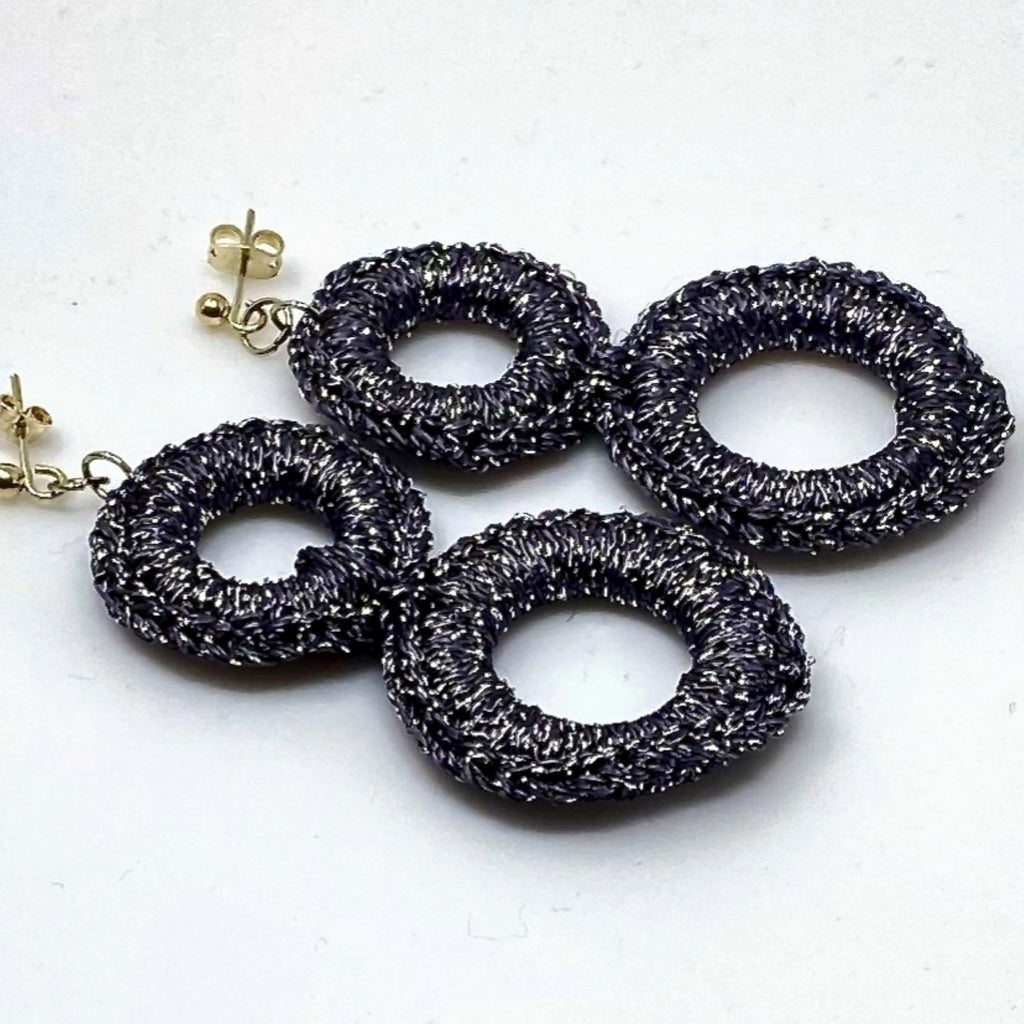 The Sienna charcoal grey crochet ring earrings arranged flat, showing the stud posts - Lodorfo