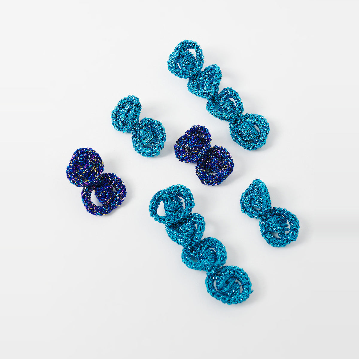 The Arlo crochet loop earrings in long and short lengths, shown in several colours - Lodorfo