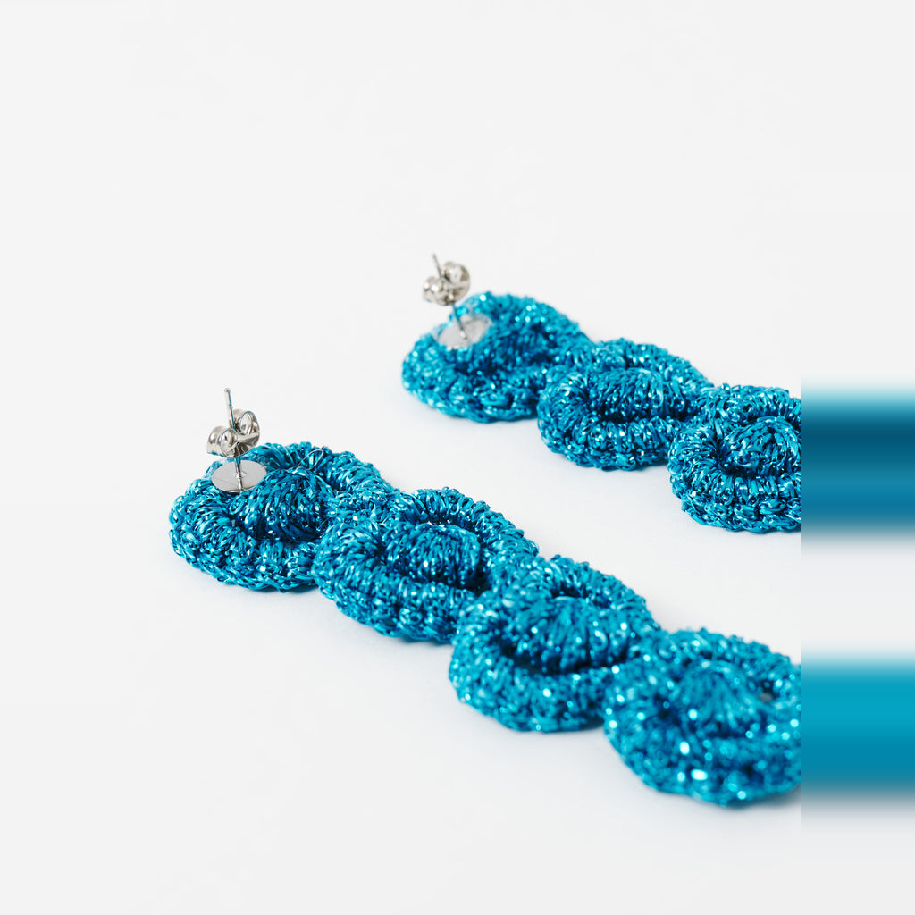 Close-up of the Arlo long deep teal four-ring crochet loop earrings, showing the stud posts - Lodorfo