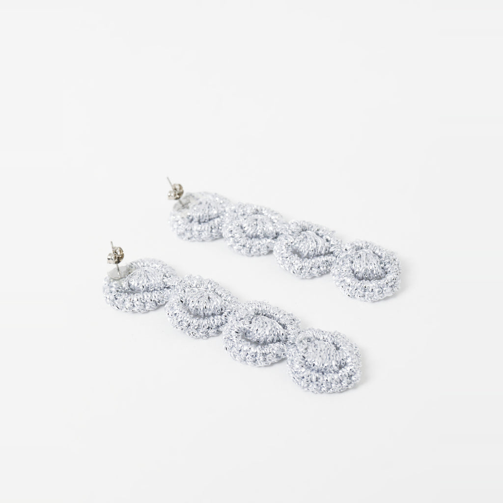 Close-up of the Arlo long silver grey four-ring crochet loop earrings, showing the stud posts - Lodorfo