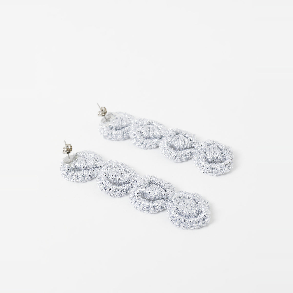 Close-up of the Arlo long silver grey four-ring crochet loop earrings, showing the stud posts - Lodorfo