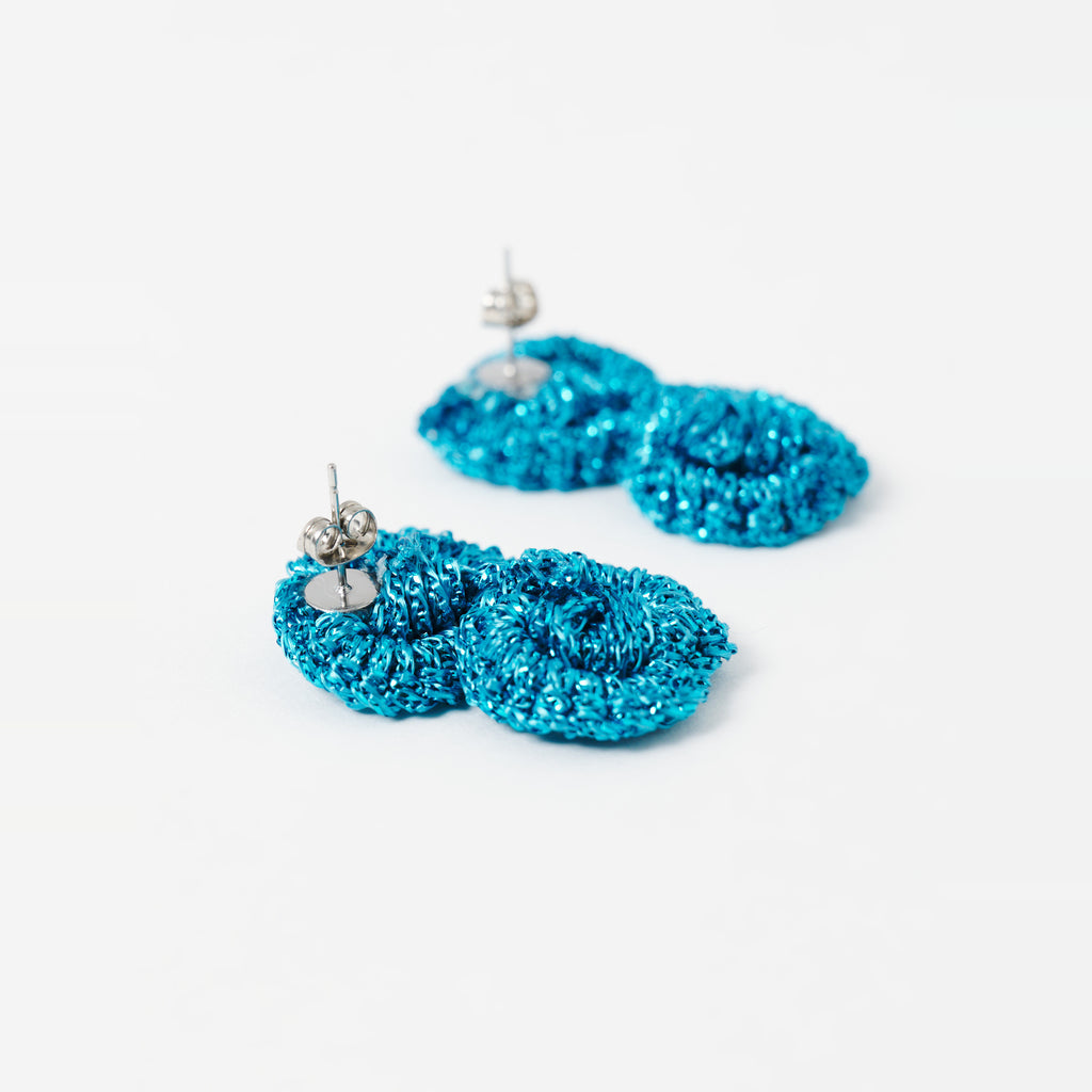 Close-up of the Arlo short deep teal two-ring crochet loop earrings, showing the stud posts - Lodorfo
