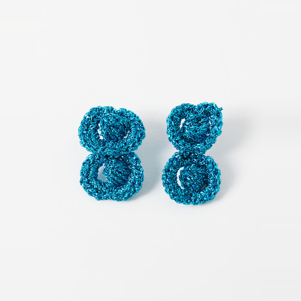 The Arlo short deep teal two-ring crochet loop earrings laid flat - Lodorfo