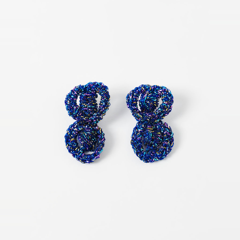 The Arlo short indigo blue two-ring crochet loop earrings laid flat - Lodorfo