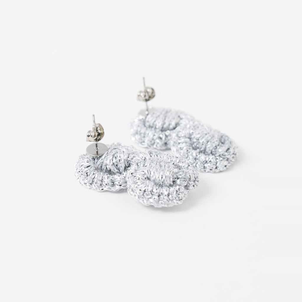 Close-up of the Arlo short silver grey two-ring crochet loop earrings, showing the stud posts - Lodorfo