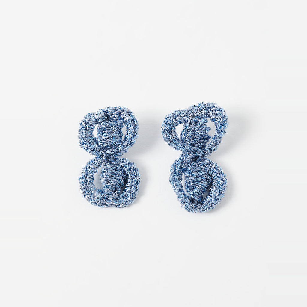 The Arlo short sky blue two-ring crochet loop earrings laid flat - Lodorfo