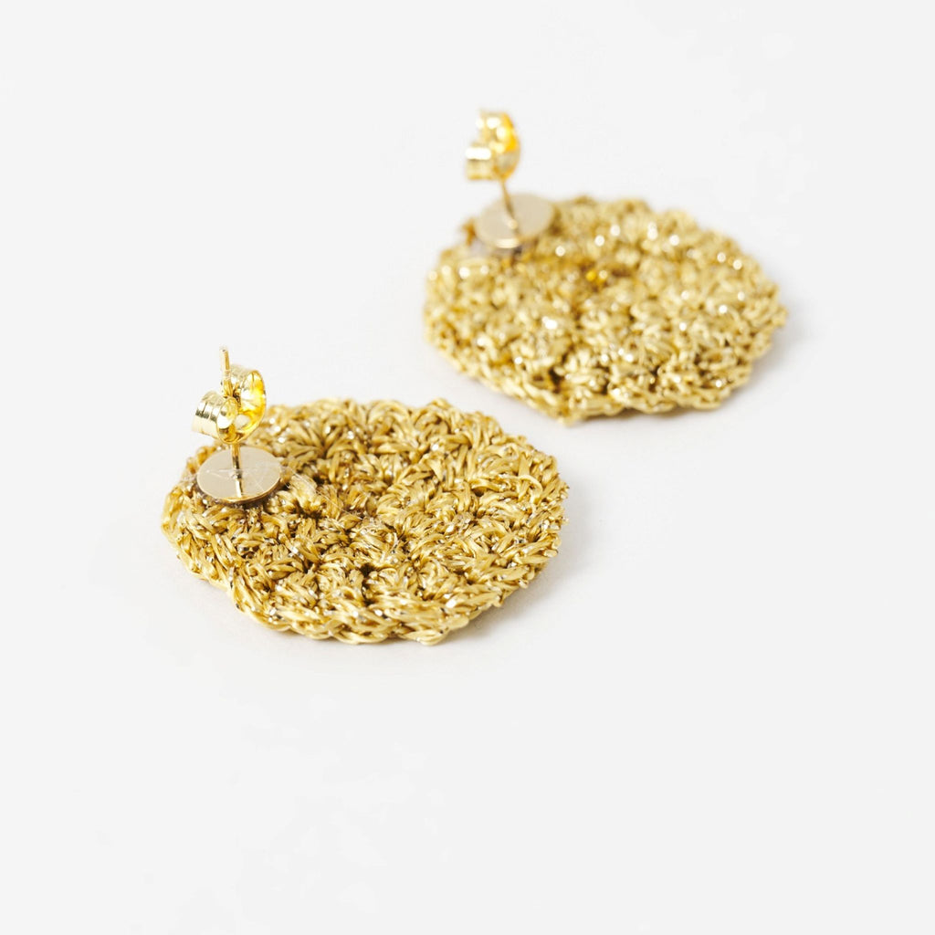 Close-up of the hand-crocheted texture of the Vela disc earrings in antique gold shimmer - Lodorfo