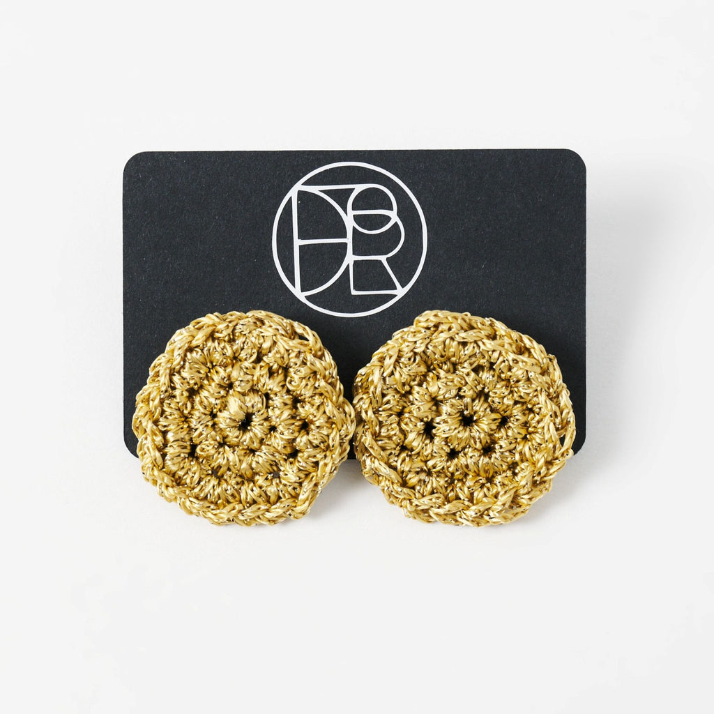 The Vela crochet disc earrings in antique gold shimmer, styled display - Lodorfo