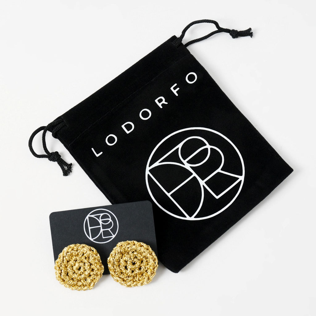 The Vela crochet disc earrings in antique gold shimmer, styled display, second view - Lodorfo