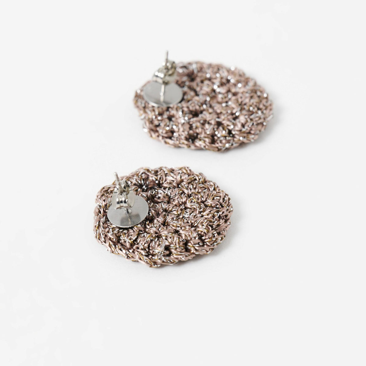 Close-up of the hand-crocheted texture of the Vela disc earrings in fawn with silver shimmer - Lodorfo