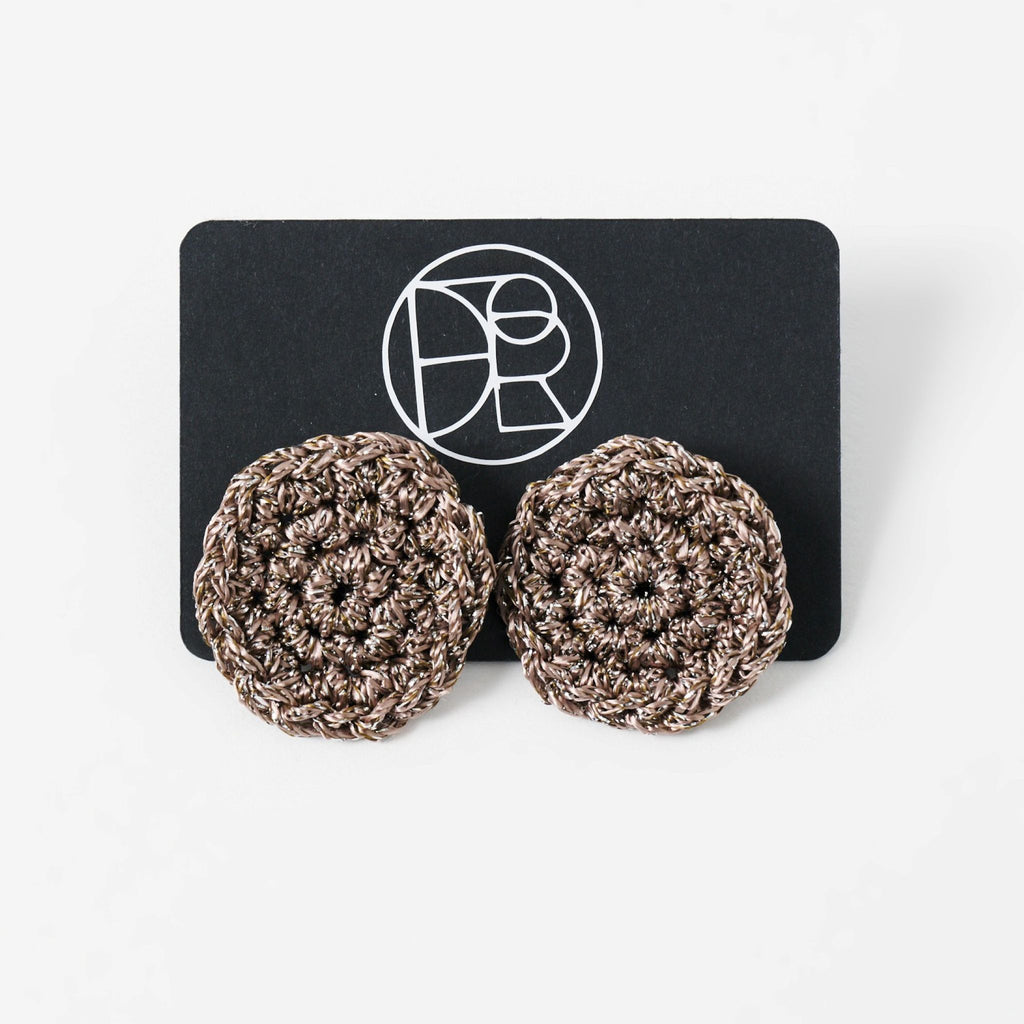 The Vela crochet disc earrings in fawn with silver shimmer, styled display - Lodorfo