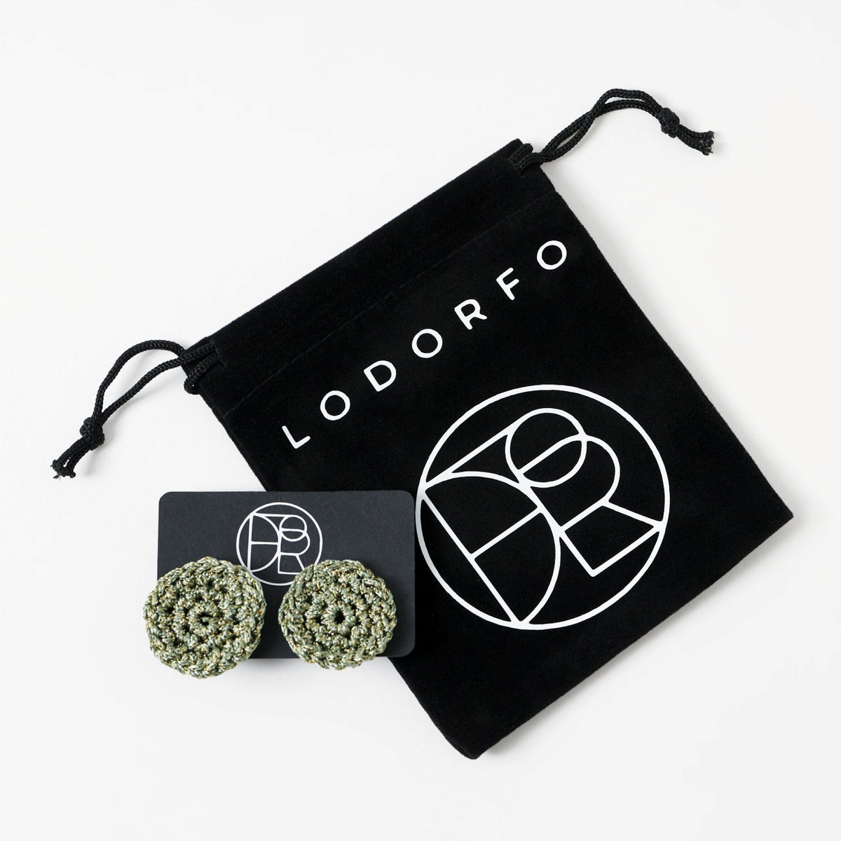 The Vela crochet disc earrings in forest green with gold shimmer, styled display, second view - Lodorfo