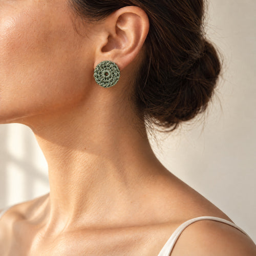 Woman wearing the Vela forest green crochet disc earring with gold shimmer, handmade UK - Lodorfo