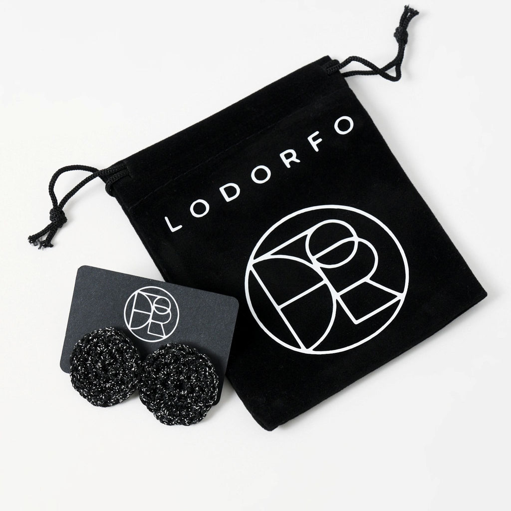 The Vela crochet disc earrings in midnight black with silver shimmer, styled display, second view - Lodorfo