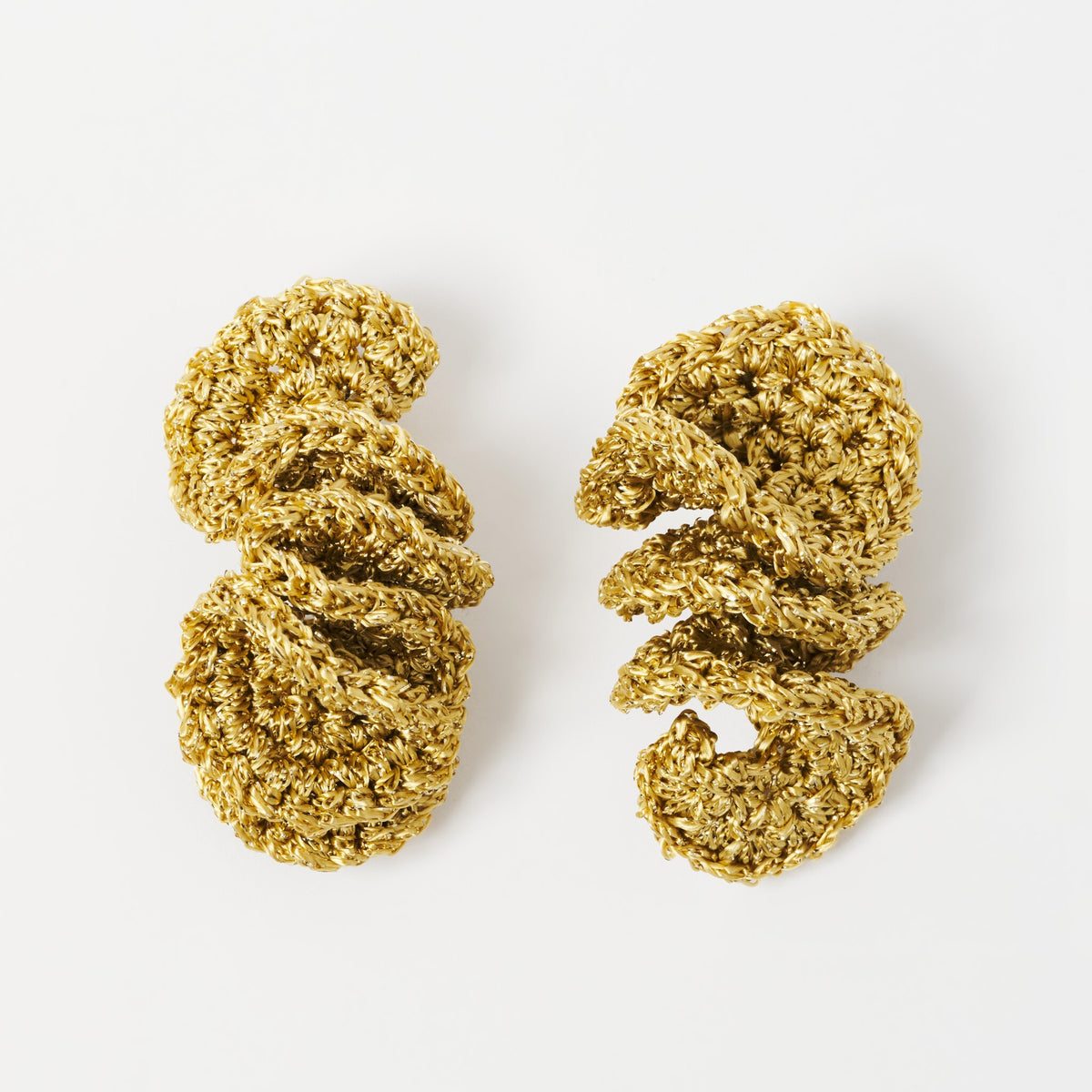 The Elara spiral drop earrings in Antique Gold Shimmer, flat lay - Lodorfo