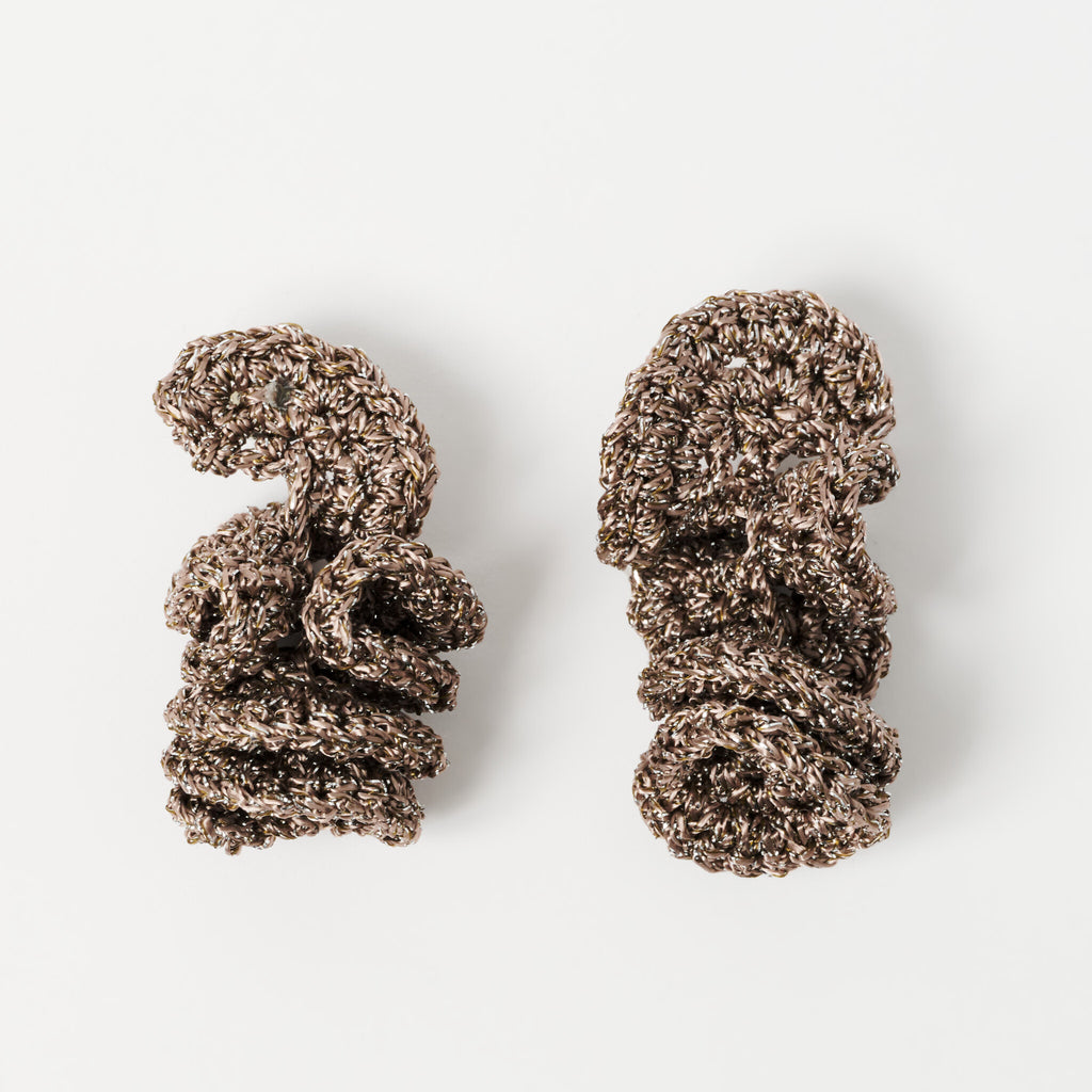 The Elara spiral drop earrings in Fawn with silver shimmer, flat lay - Lodorfo