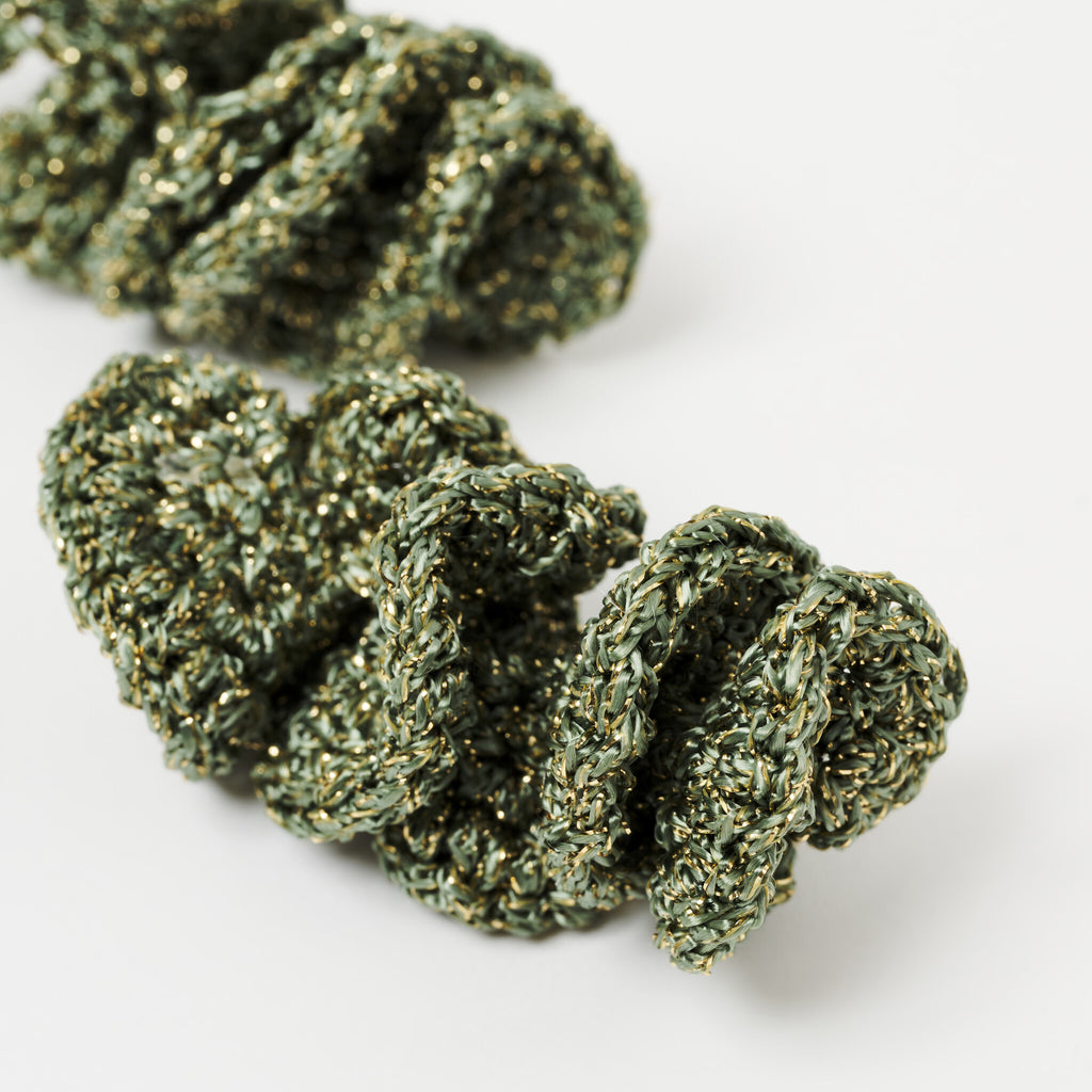 The Elara spiral drop earrings in Forest Green with gold shimmer, close up - Lodorfo